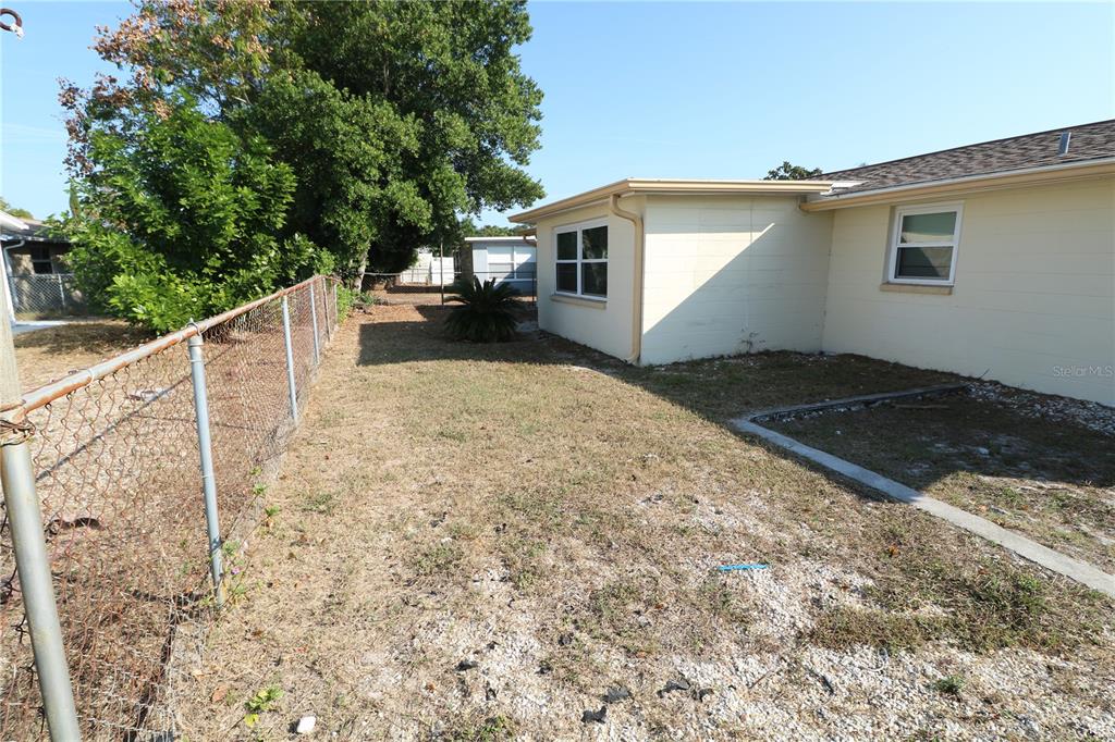 7825 Birchwood Drive Port Richey, FL 34668 - Photo 43 of 43 a view of a house with a backyard