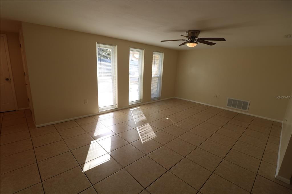 7825 Birchwood Drive Port Richey, FL 34668 - Photo 8 of 43 a view of a livingroom with an empty space and a window