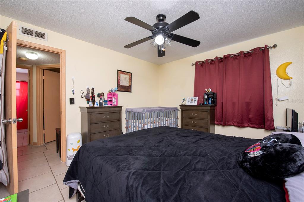 725 Michigan Court, Unit 3 St. Cloud, FL 34769 - Photo 7 of 12 a bedroom with a bed closet and a window