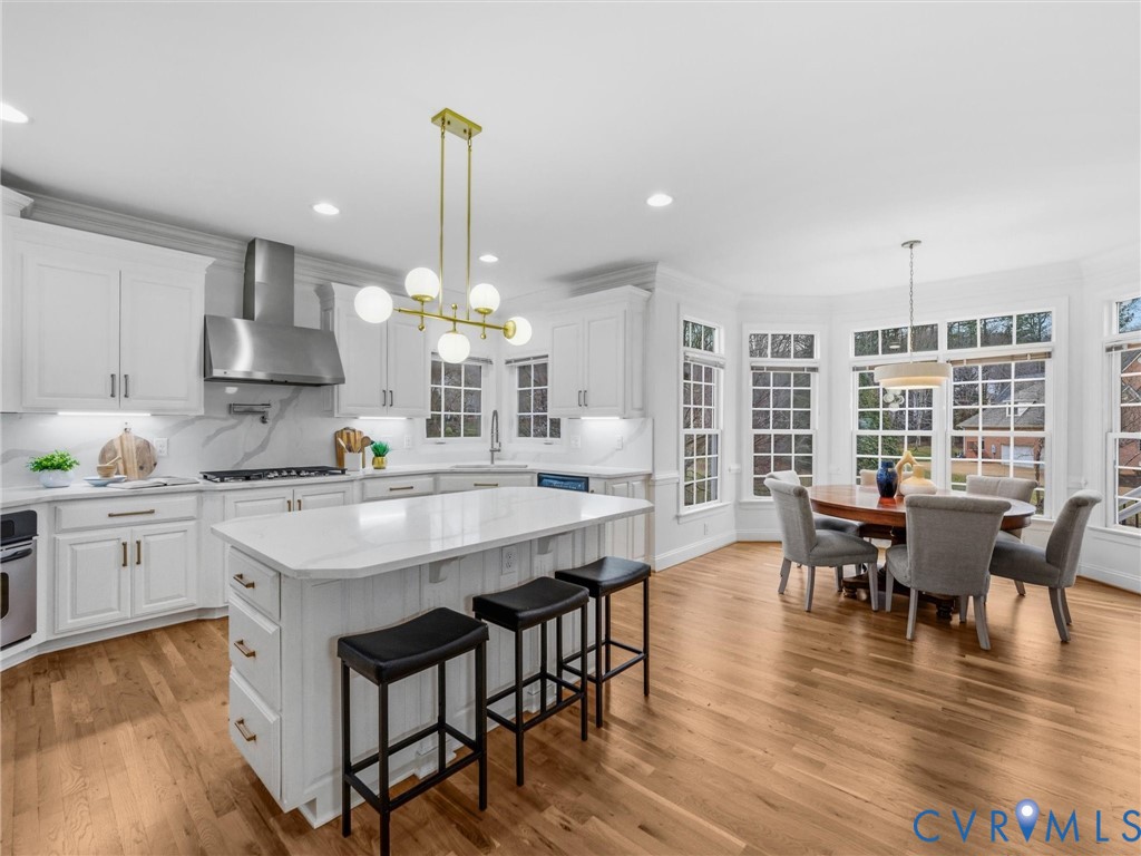 14335 Lander Road Midlothian, VA 23113 - Photo 15 of 70 a kitchen with stainless steel appliances granite countertop a kitchen island hardwood floor sink stove dining table and chairs