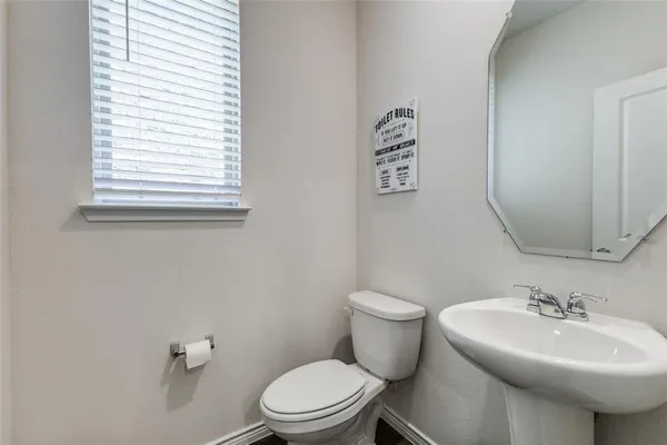 a bathroom with a sink a mirror and a toilet
