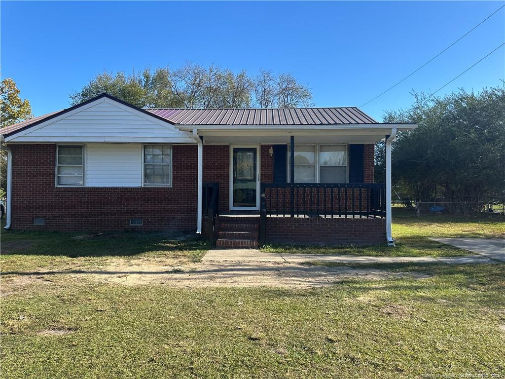 1224 East Manchester Road Spring Lake, NC 28390 - Photo 1 of 12 a view of a house with a swimming pool and a yard