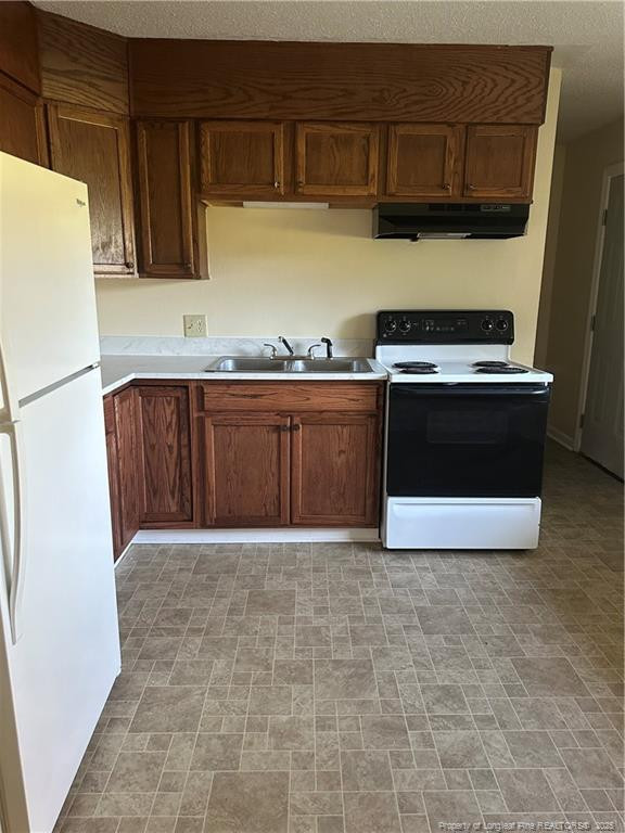 1224 East Manchester Road Spring Lake, NC 28390 - Photo 3 of 12 a kitchen with granite countertop a stove a sink and a refrigerator