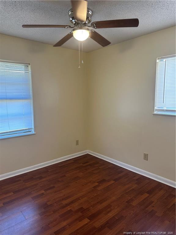 1224 East Manchester Road Spring Lake, NC 28390 - Photo 8 of 12 a view of an empty room with wooden floor and a window