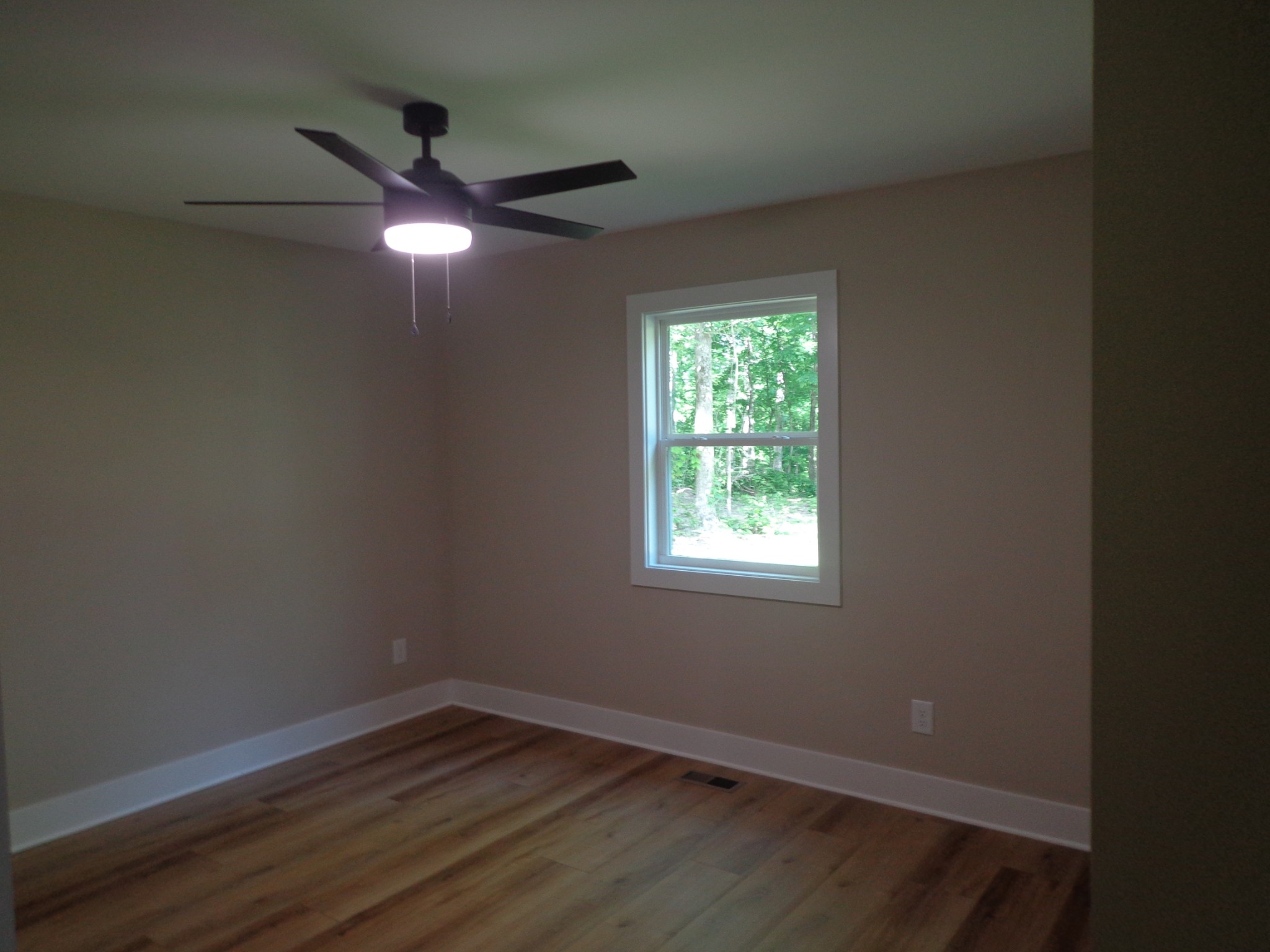 700 Hillcrest Road Waverly, TN 37185 - Photo 17 of 49 an empty room with wooden floor and windows