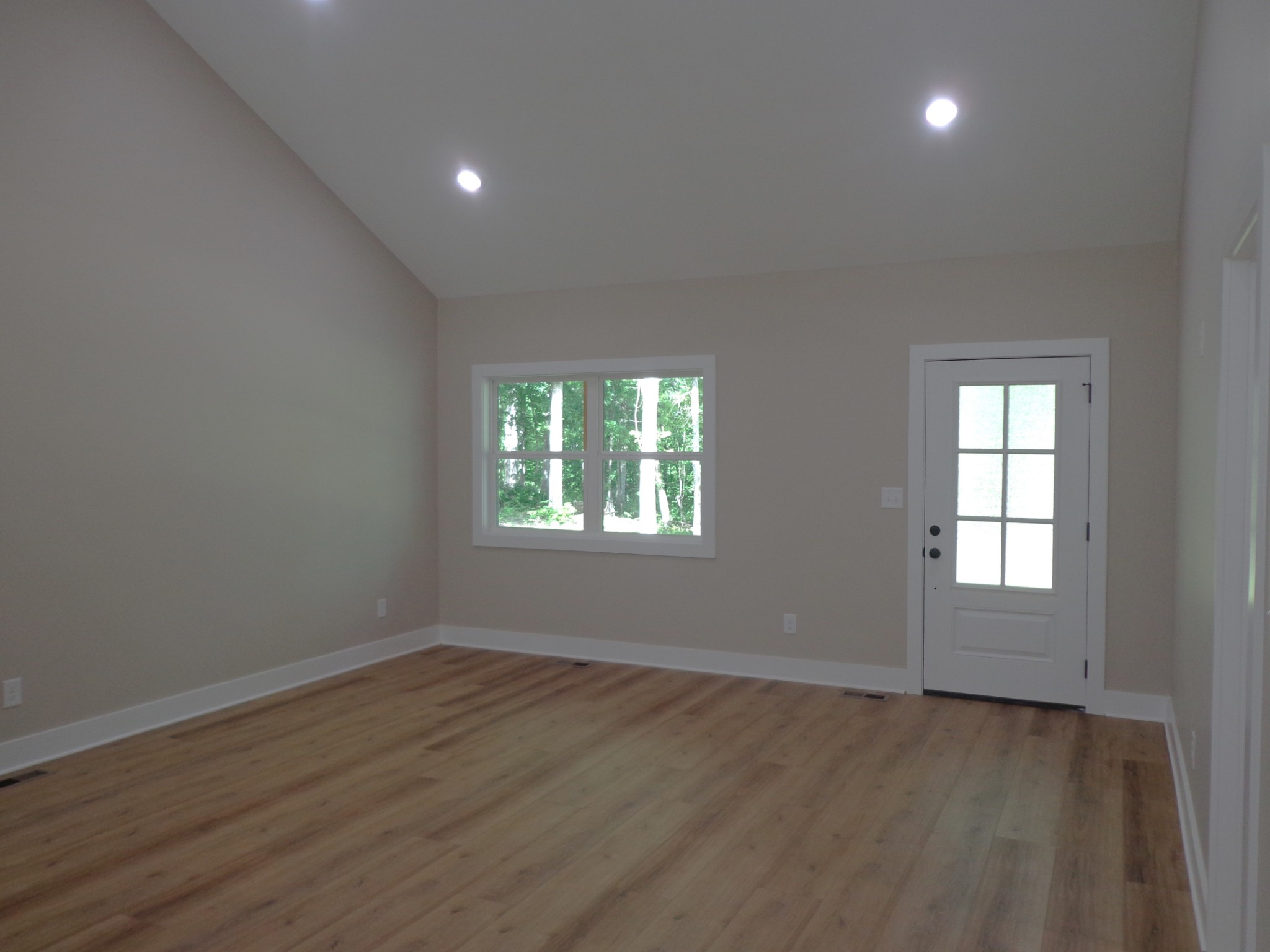 700 Hillcrest Road Waverly, TN 37185 - Photo 6 of 49 an empty room with wooden floor and windows