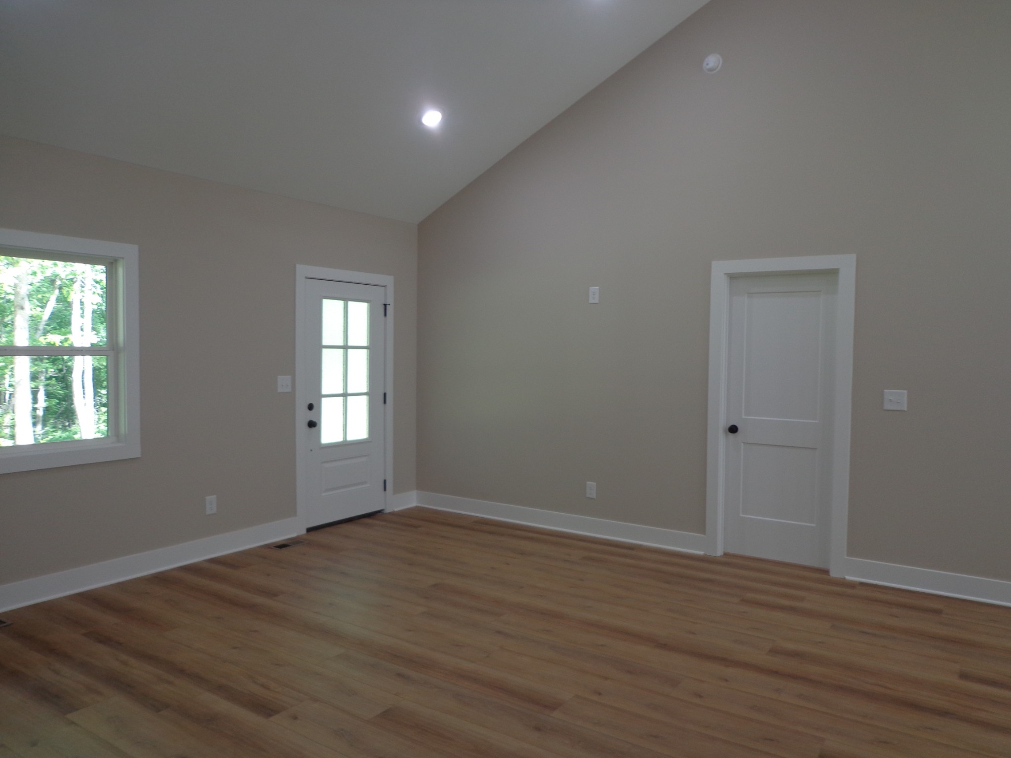 700 Hillcrest Road Waverly, TN 37185 - Photo 7 of 49 a view of an empty room with wooden floor and a window