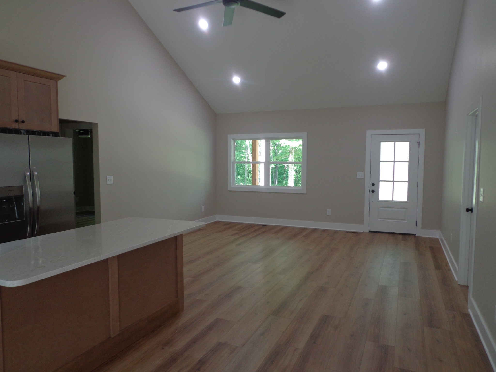 700 Hillcrest Road Waverly, TN 37185 - Photo 9 of 49 an empty room with wooden floor and windows