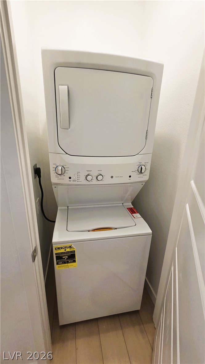 509 Arthur Pointe Street Henderson, NV 89011 - Photo 9 of 12 Compact stacked laundry unit offers convenience within a dedicated utility space.