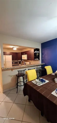 a kitchen with stainless steel appliances granite countertop a stove and a refrigerator