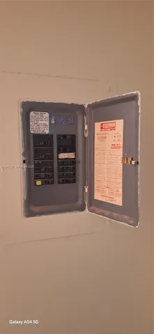 a view of a patio with a table and chairs under an umbrella