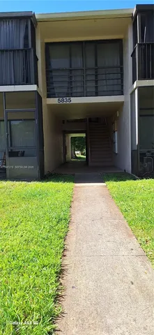 a view of a big yard with a large tree