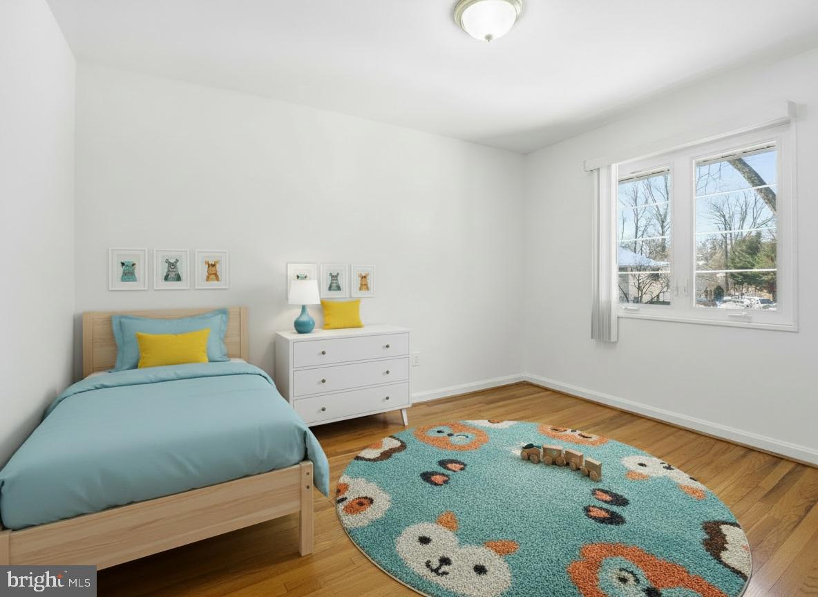 5364 Pooks Hill Road Bethesda, MD 20814 - Photo 15 of 25 a bedroom with a bed and wooden floor
