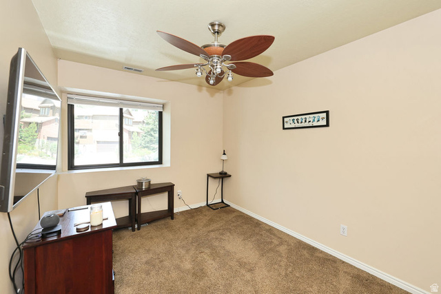 3104 East High Danish Road Sandy, UT 84093 - Photo 24 of 36 second floor bedroom (2 of 3 upper ) Window-equipped room featuring light-toned walls, a textured carpet, a ceiling fan with integrated lighting, and white baseboards
