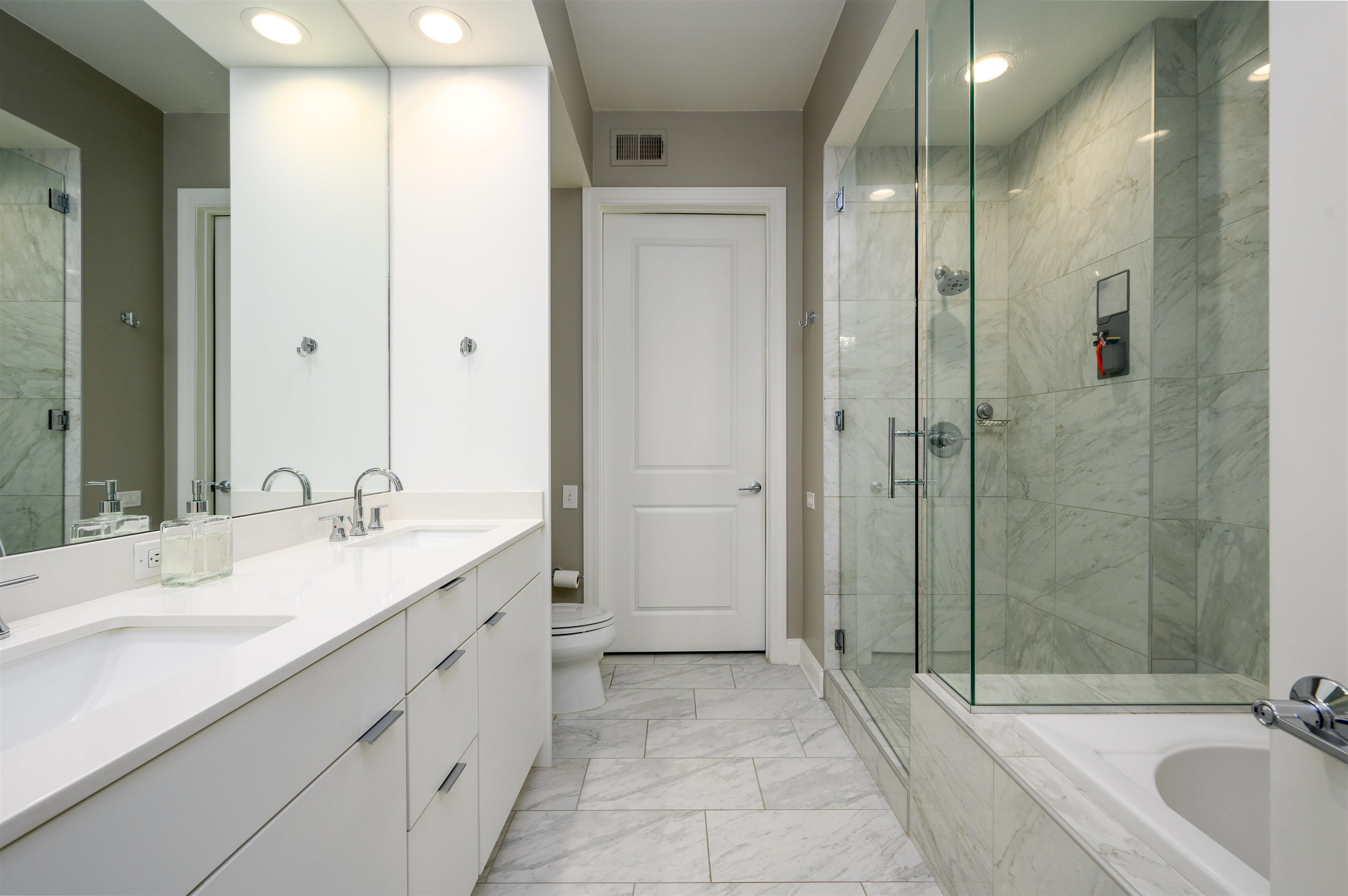 717 Riverside Drive, Unit 510 Memphis, TN 38103 - Photo 11 of 34 a bathroom with a double vanity sink and a mirror
