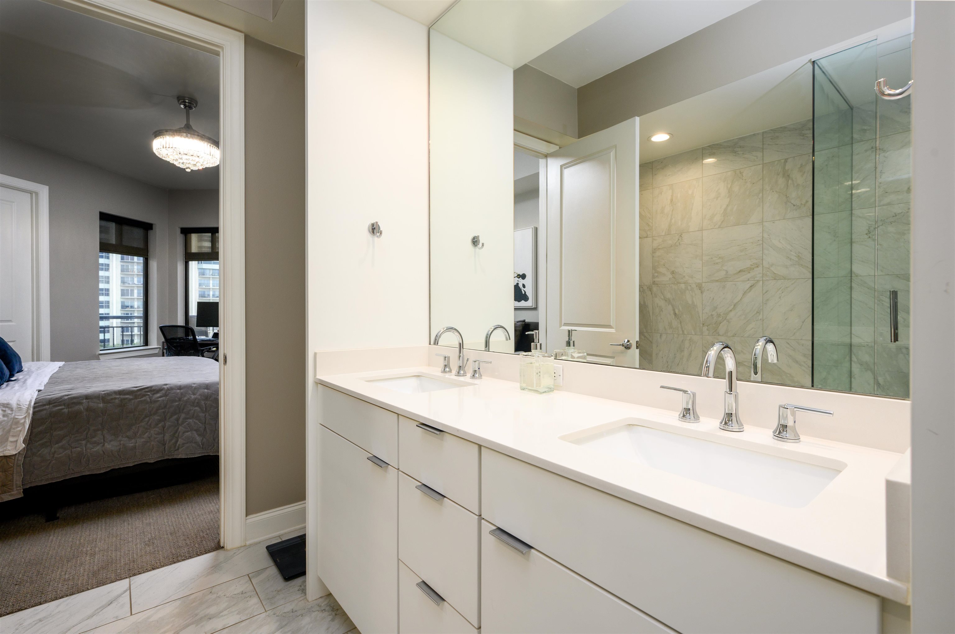 717 Riverside Drive, Unit 510 Memphis, TN 38103 - Photo 12 of 34 a en suite bathroom with a double vanity sink and a mirror