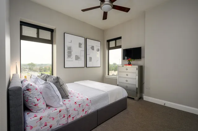 a bedroom with a bed dresser and a window