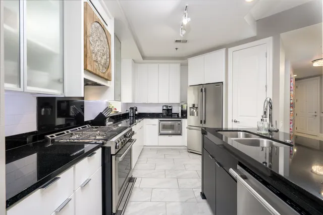 a kitchen with a sink stove and refrigerator