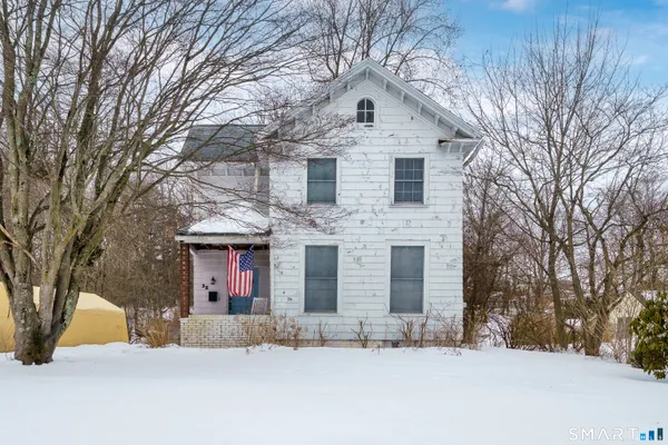 a view of house with a yard covered in snow