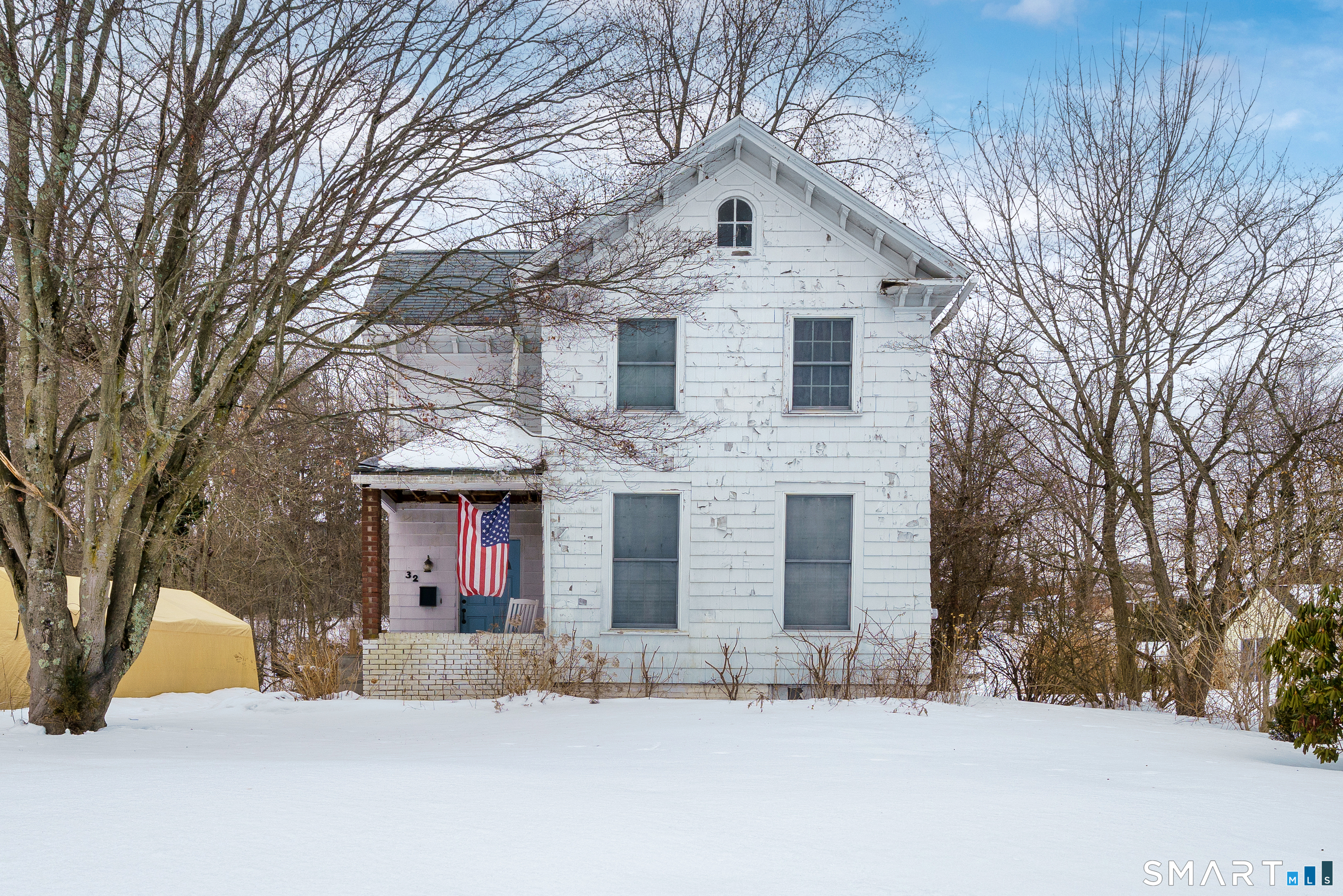 a view of house with a yard covered in snow