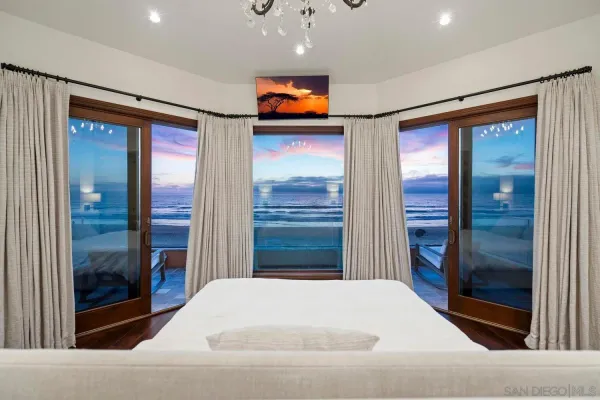 a spacious bedroom with a bed and a fireplace