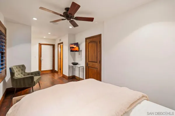 a large bed sitting in a bedroom next to a window