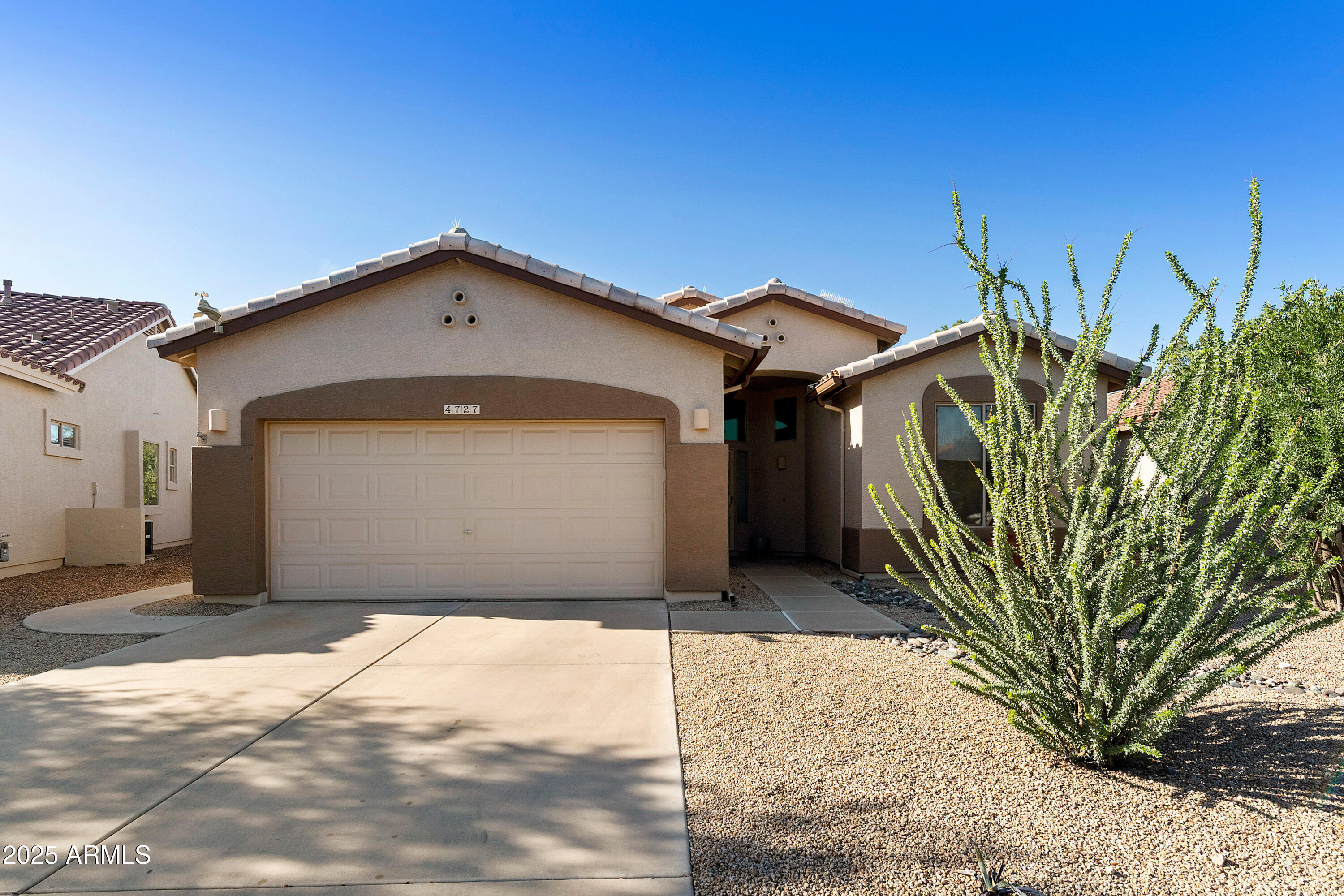 4727 East Azalea Drive Gilbert, AZ 85298 - Photo 4 of 46 a front view of a house with a yard and garage