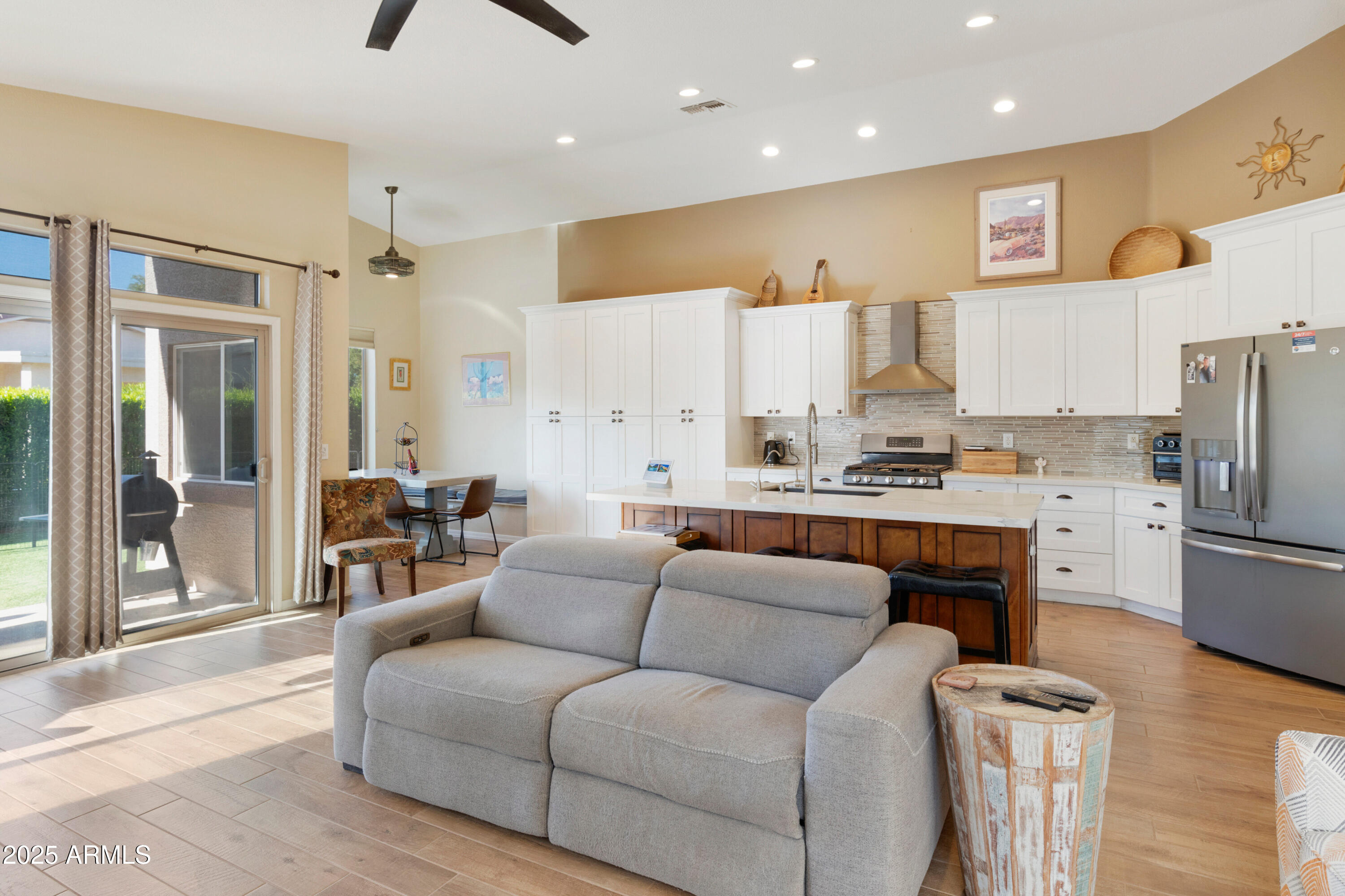 4727 East Azalea Drive Gilbert, AZ 85298 - Photo 8 of 46 a living room with stainless steel appliances furniture and a view of kitchen