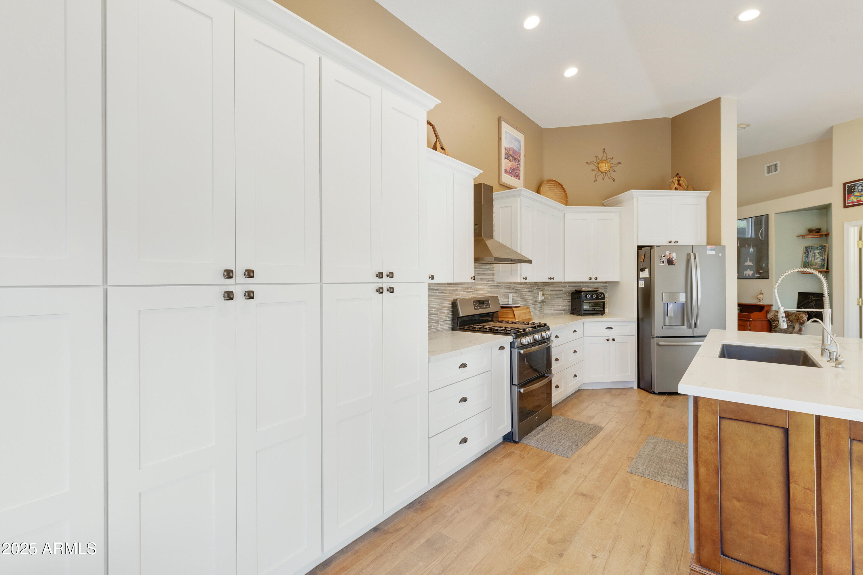 4727 East Azalea Drive Gilbert, AZ 85298 - Photo 10 of 46 a kitchen with white cabinets and stainless steel appliances