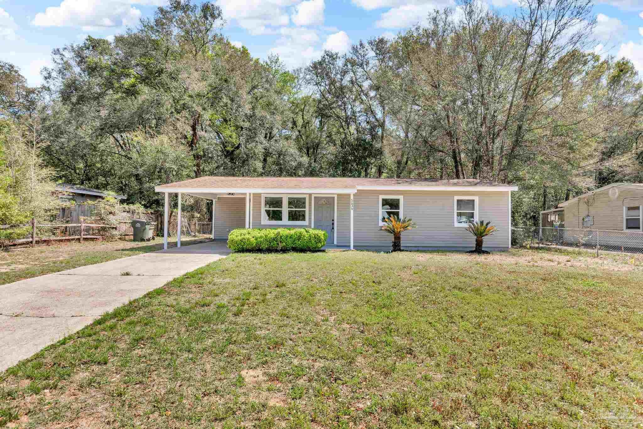a view of a house with a yard and garage