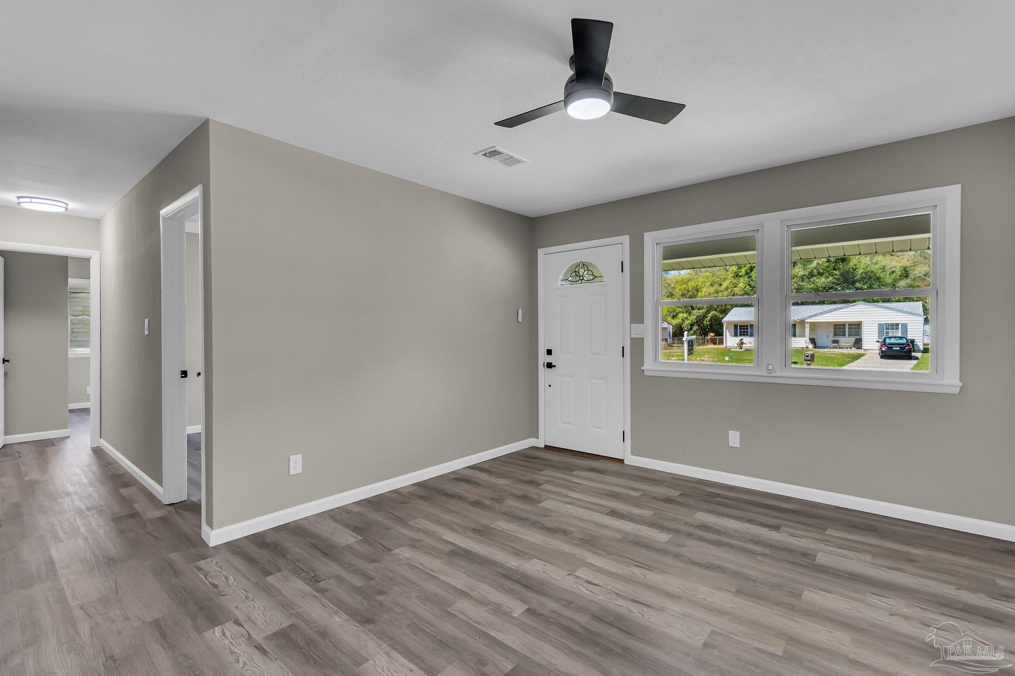 5636 Avondale Road Pensacola, FL 32526 - Photo 2 of 22 wooden floor in an empty room with a window
