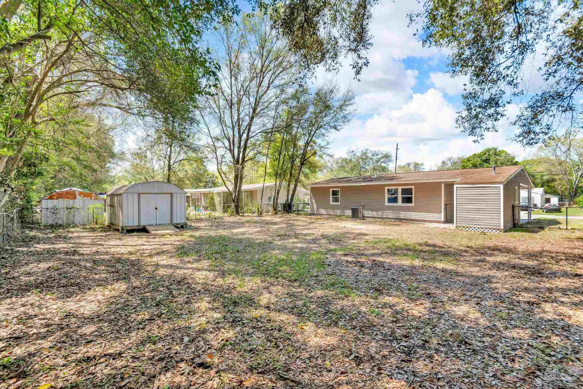 5636 Avondale Road Pensacola, FL 32526 - Photo 22 of 22 a house with trees in front of it