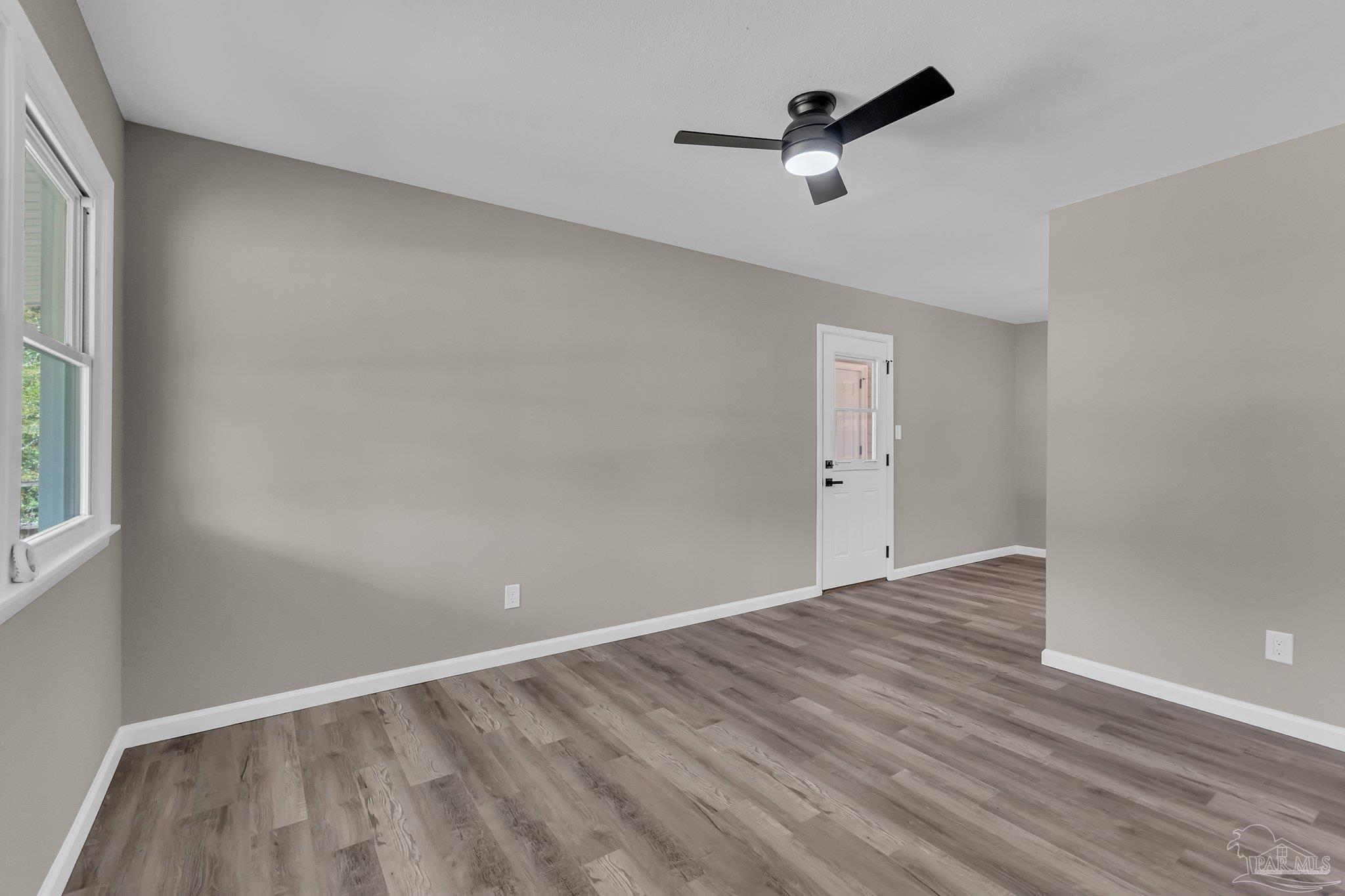 5636 Avondale Road Pensacola, FL 32526 - Photo 4 of 22 wooden floor in an empty room with a window