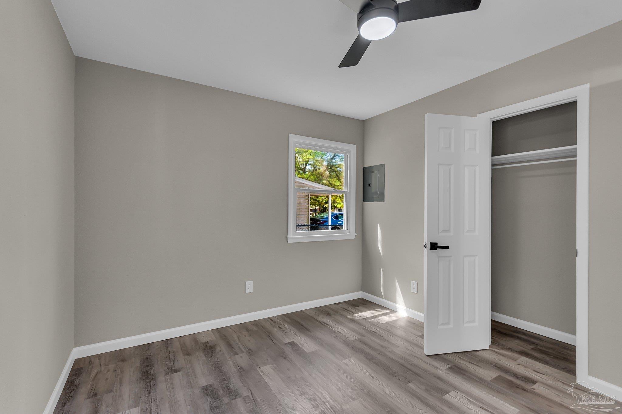 5636 Avondale Road Pensacola, FL 32526 - Photo 9 of 22 a view of an empty room with wooden floor and a window