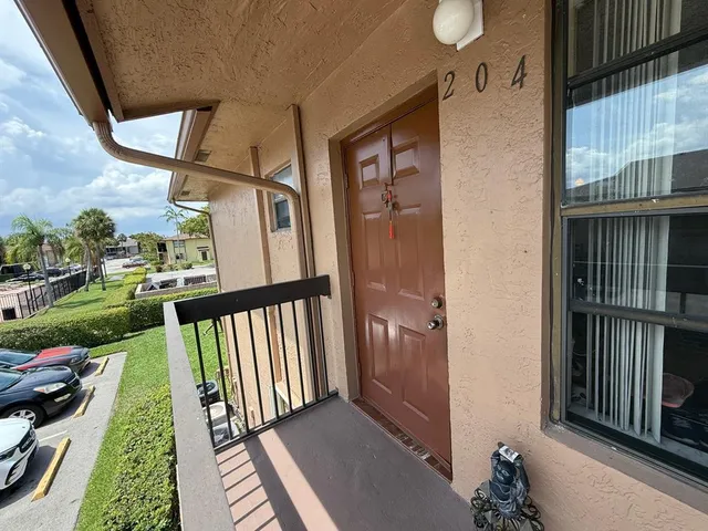 a view of a house with a big yard and sitting area