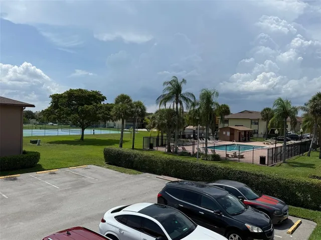a view of a house with a yard and sitting area