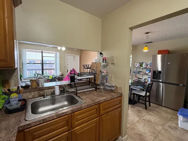 a bedroom with a bed dresser and a window