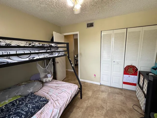 a bedroom with a bed dresser and a window