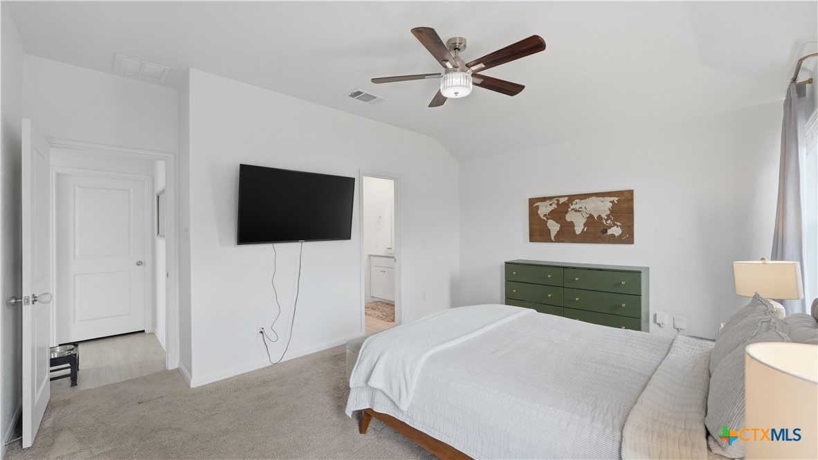 1949 Redstart New Braunfels, TX 78130 - Photo 11 of 32 a bedroom with a bed and a flat screen tv