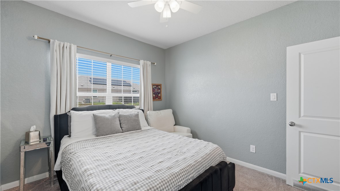 1949 Redstart New Braunfels, TX 78130 - Photo 18 of 32 a bedroom with a bed and a chandelier