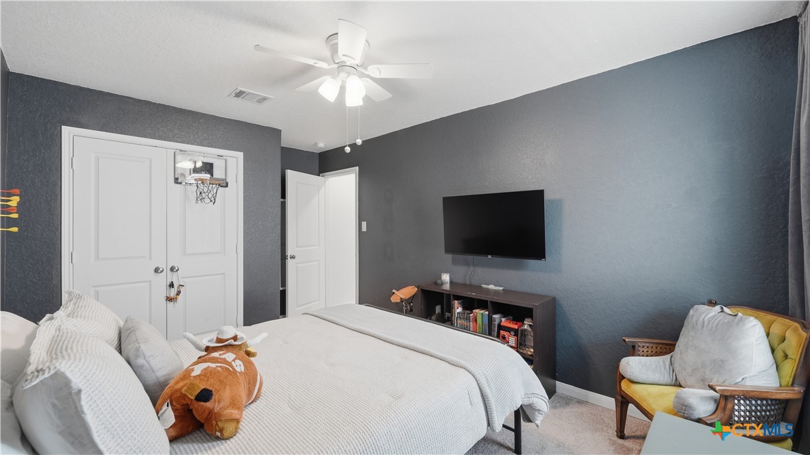 1949 Redstart New Braunfels, TX 78130 - Photo 22 of 32 a bedroom with a bed and a flat screen tv
