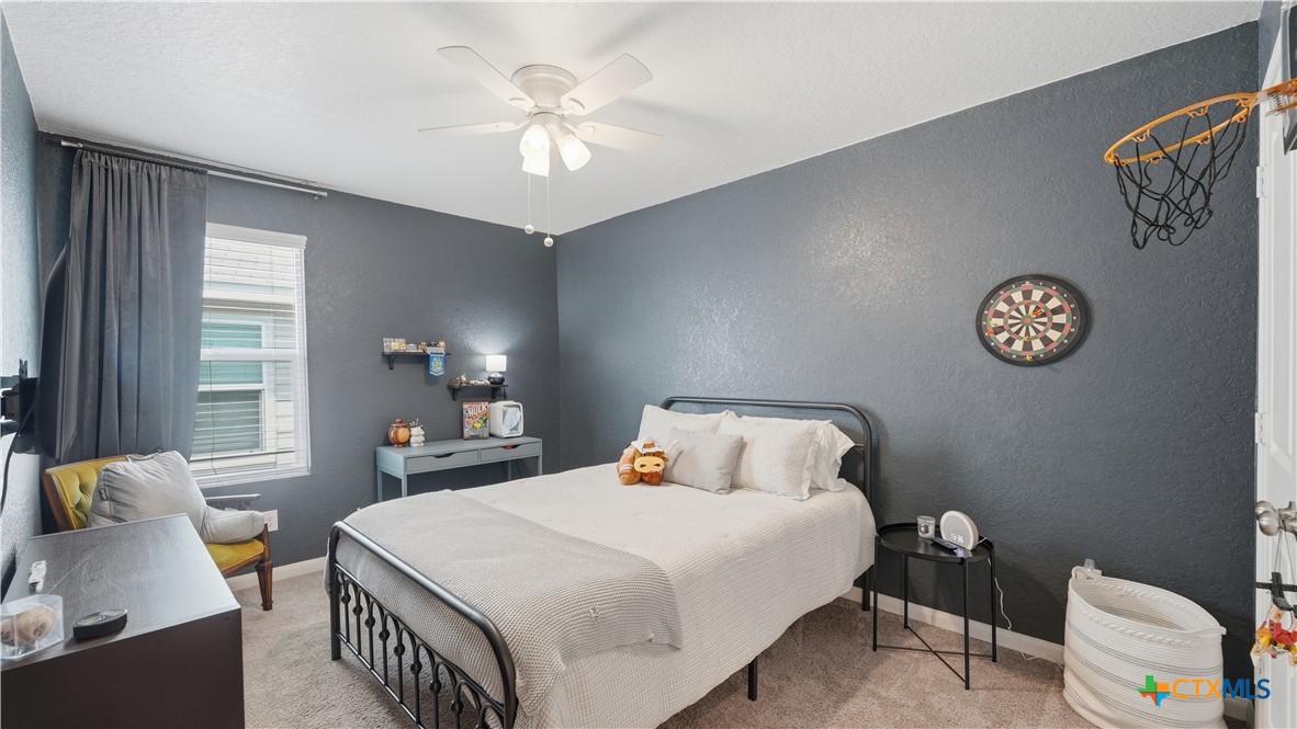 1949 Redstart New Braunfels, TX 78130 - Photo 23 of 32 a bedroom with a bed and a chandelier