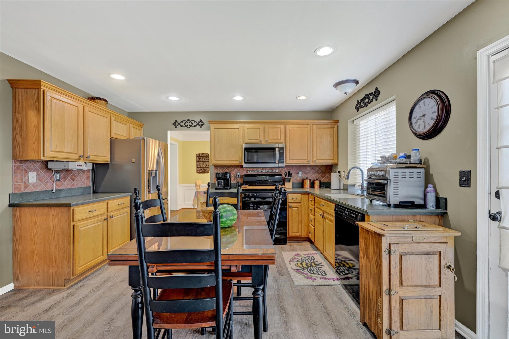 4642 Bucks School House Road Rosedale, MD 21237 - Photo 11 of 33 a kitchen with cabinets and stainless steel appliances
