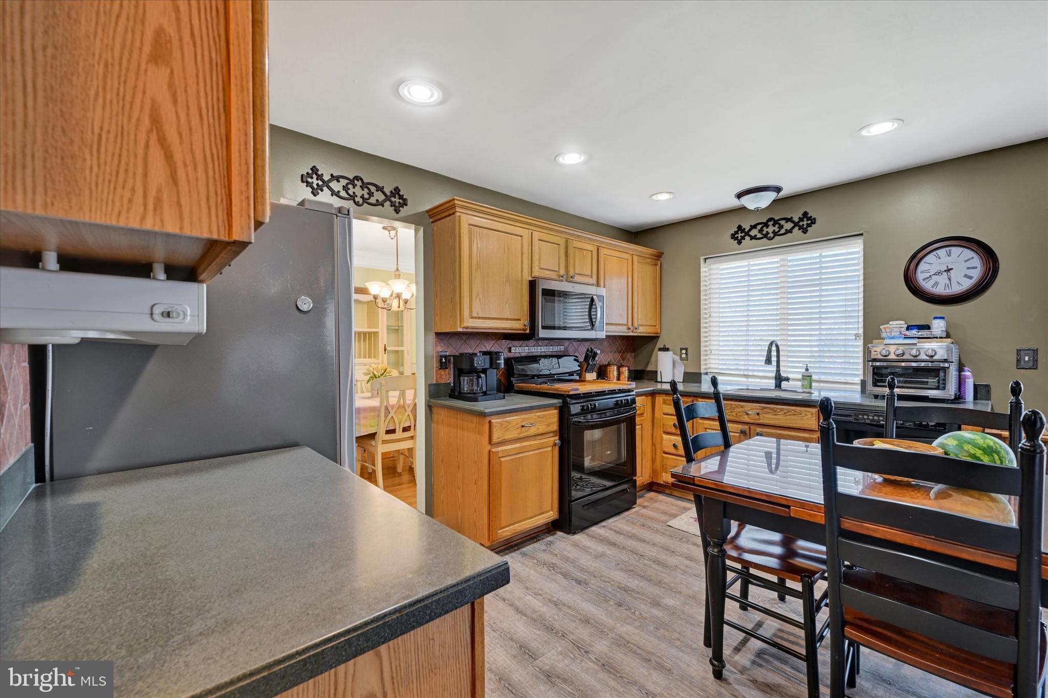 4642 Bucks School House Road Rosedale, MD 21237 - Photo 13 of 33 a kitchen with stainless steel appliances granite countertop a refrigerator stove microwave and sink