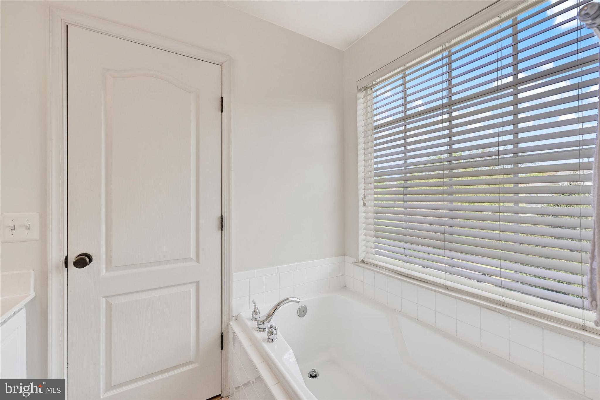 4642 Bucks School House Road Rosedale, MD 21237 - Photo 22 of 33 a bathroom with a bathtub and shower