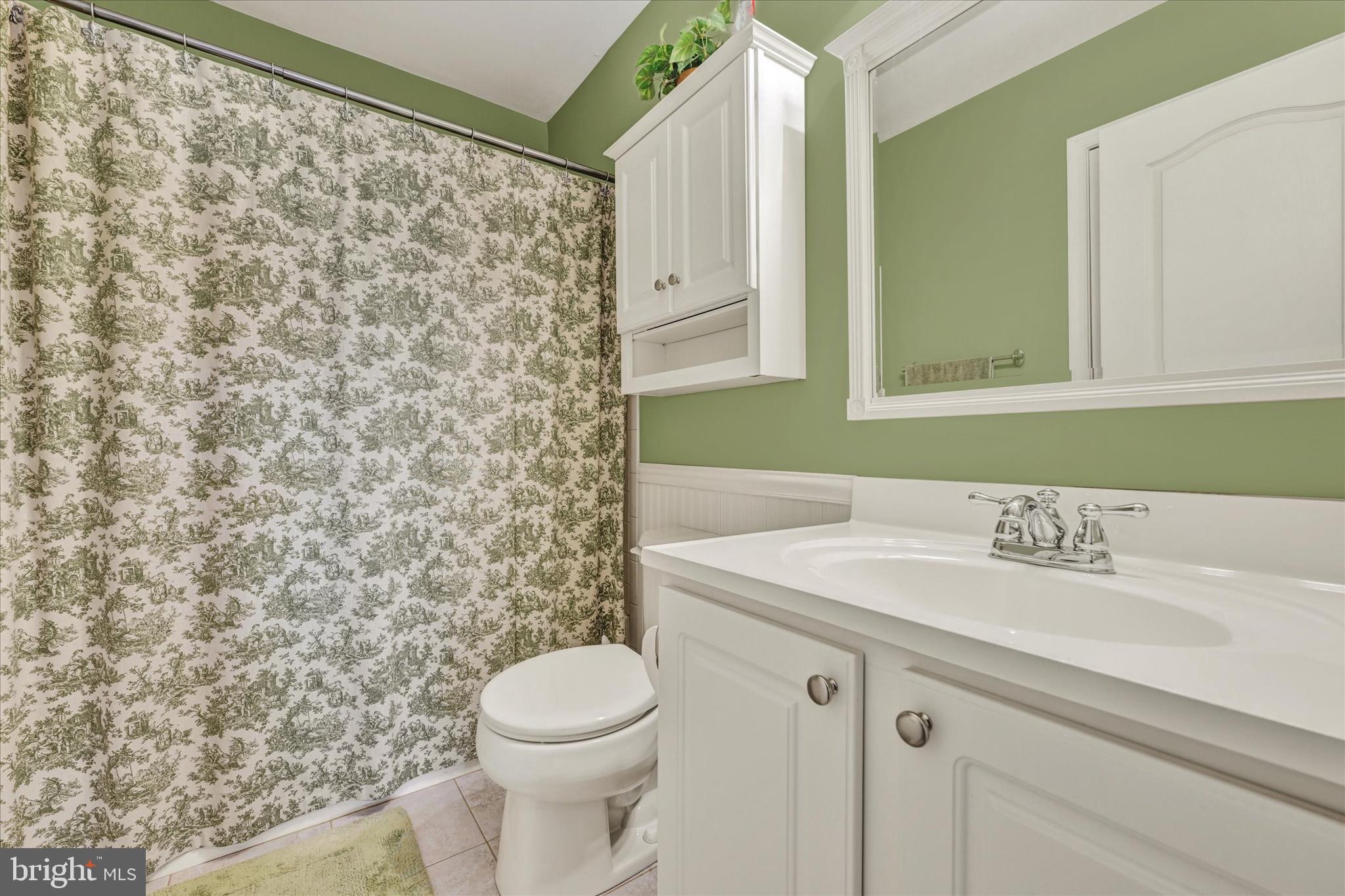 4642 Bucks School House Road Rosedale, MD 21237 - Photo 25 of 33 a bathroom with a sink a toilet and a mirror