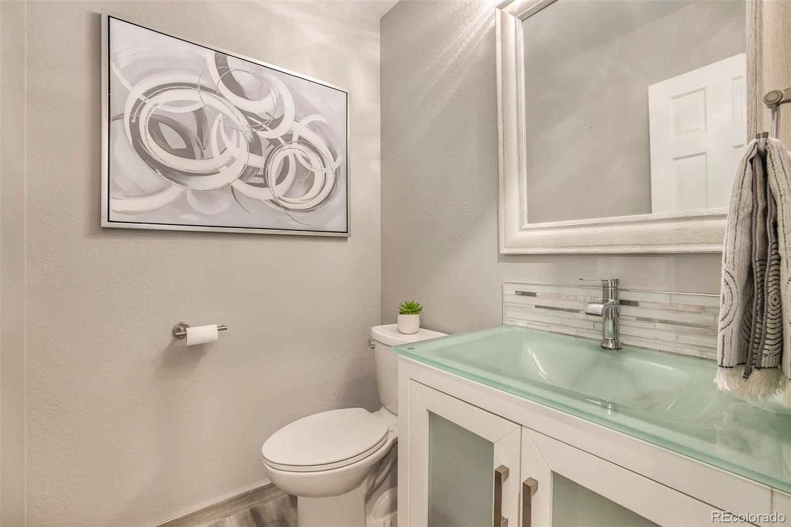 2365 Perry Street Denver, CO 80212 - Photo 15 of 24 a bathroom with a granite countertop sink and a toilet