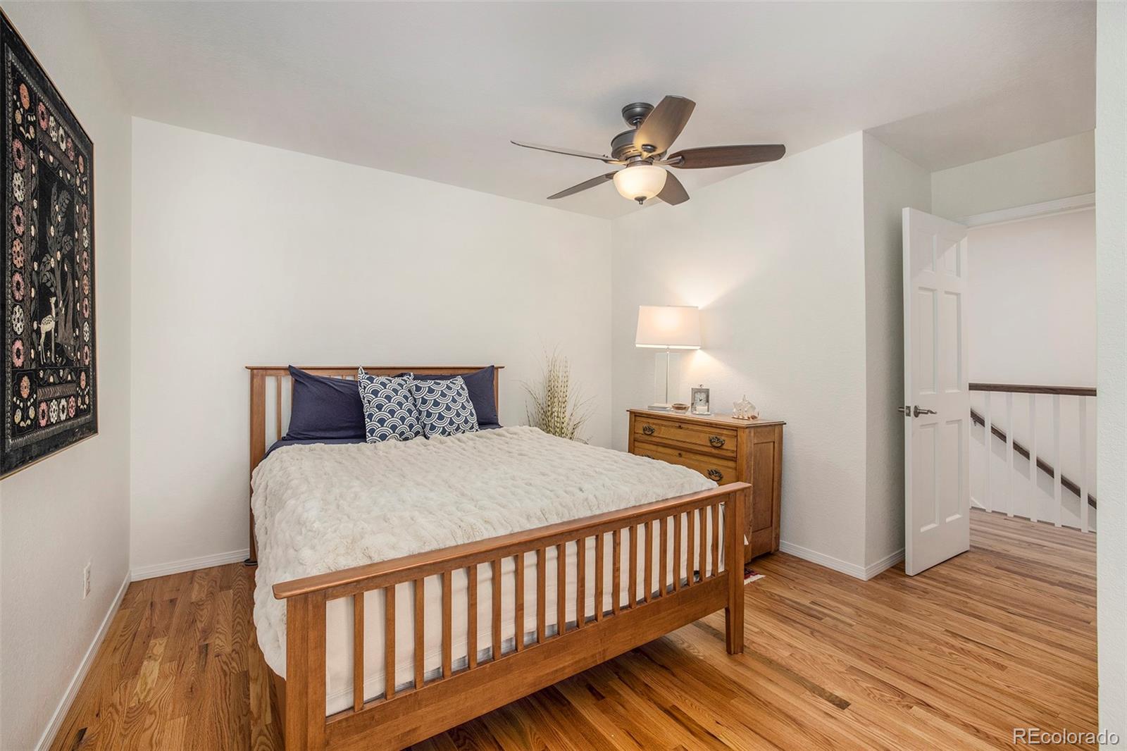 2365 Perry Street Denver, CO 80212 - Photo 19 of 24 a bedroom with a bed and wooden floor