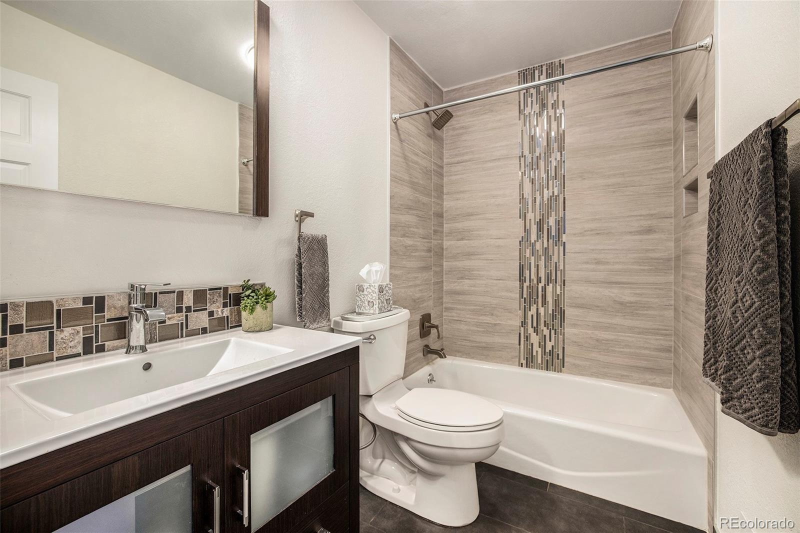 2365 Perry Street Denver, CO 80212 - Photo 21 of 24 a bathroom with a sink a toilet and shower