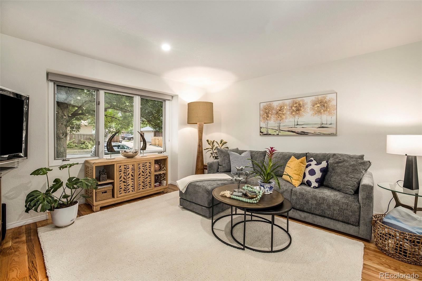 2365 Perry Street Denver, CO 80212 - Photo 5 of 24 a living room with furniture a flat screen tv and a large window
